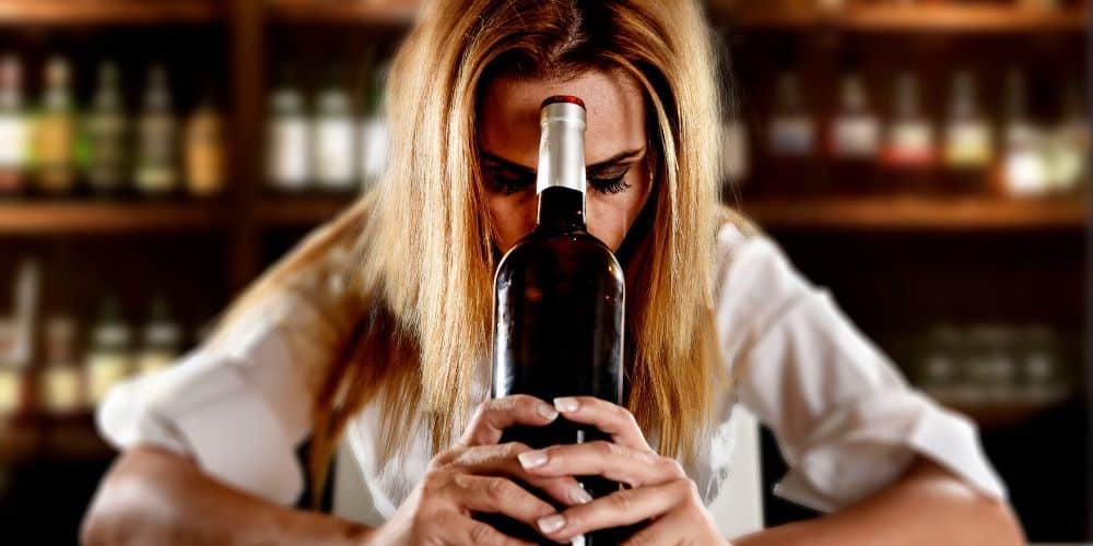 Am I an alcohol? Myths and misconceptions about problem drinking. Woman with wine bottle.