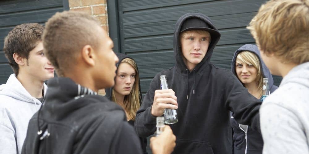 How can I talk to a teenager about drinking? A group of teenagers holding bottles.