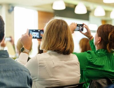 Two people taking photos of the stage