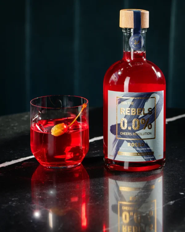 Rebels Rosso aperitif bottle with a cocktail in a glass